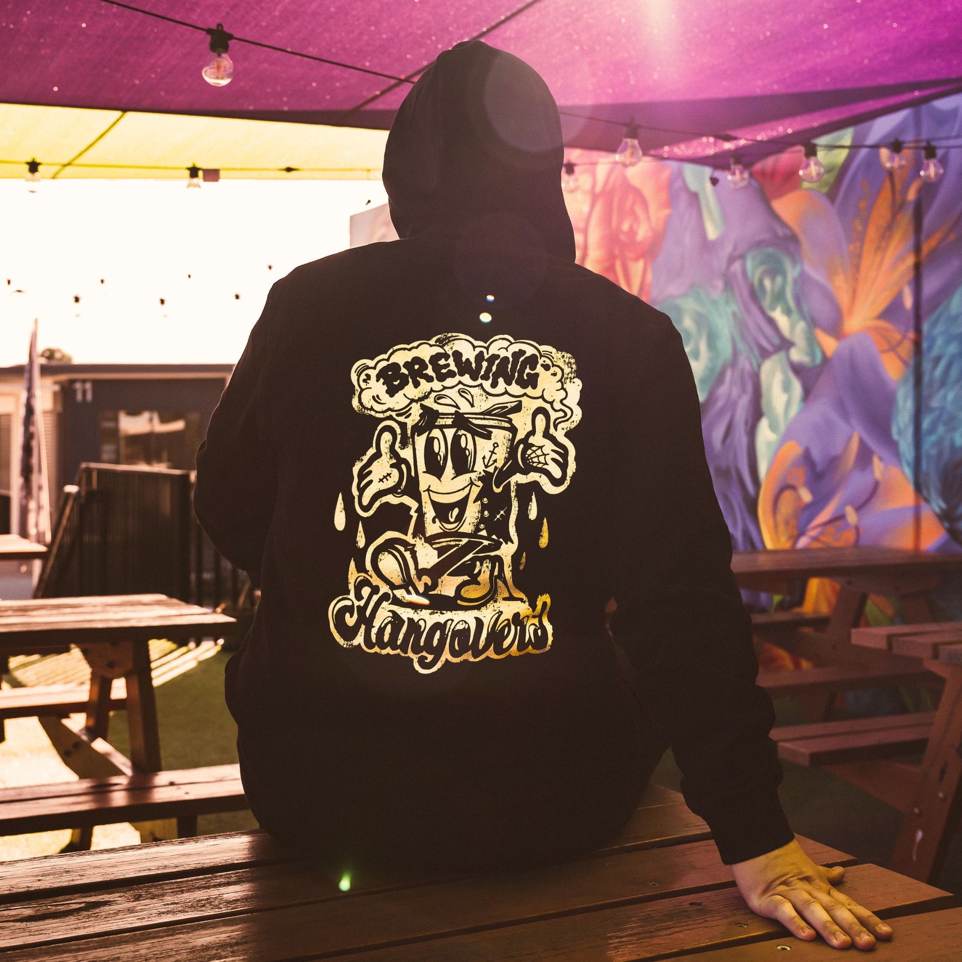 Black hoodie with Blackflag Brewing logo on front and Brewing Hangovers illustration on back.